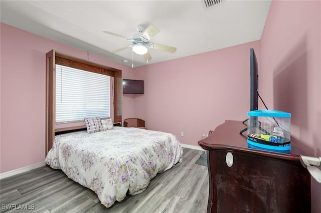 bedroom featuring hardwood / wood-style flooring and ceiling fan