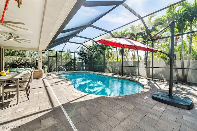 view of pool featuring a lanai, ceiling fan, and a patio area