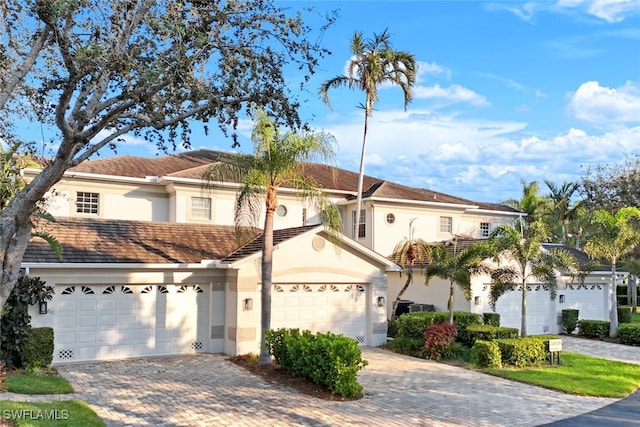 mediterranean / spanish home featuring a garage