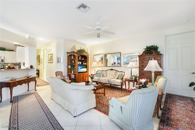 tiled living room with ceiling fan