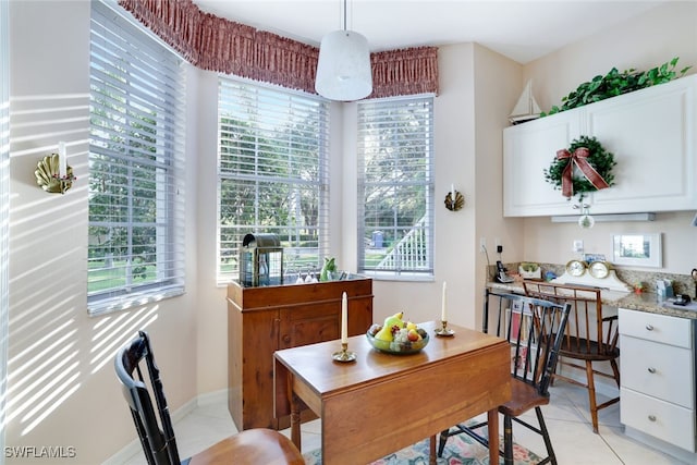 dining space featuring light tile patterned flooring