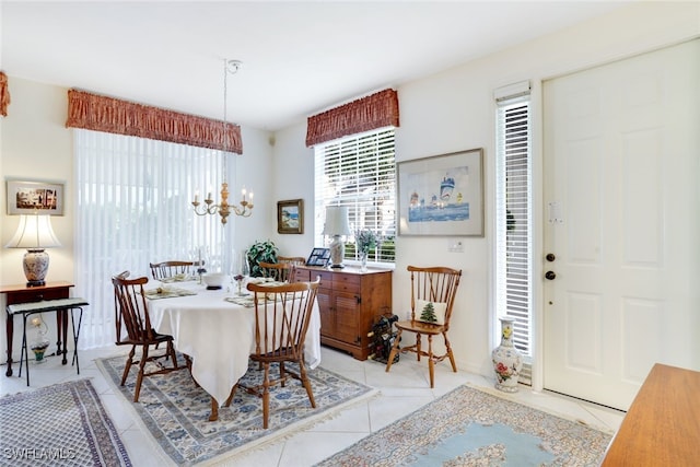 tiled dining area featuring a notable chandelier