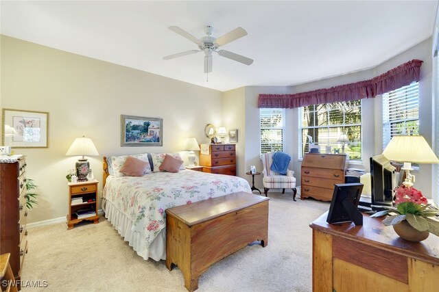 bedroom with ceiling fan and light carpet