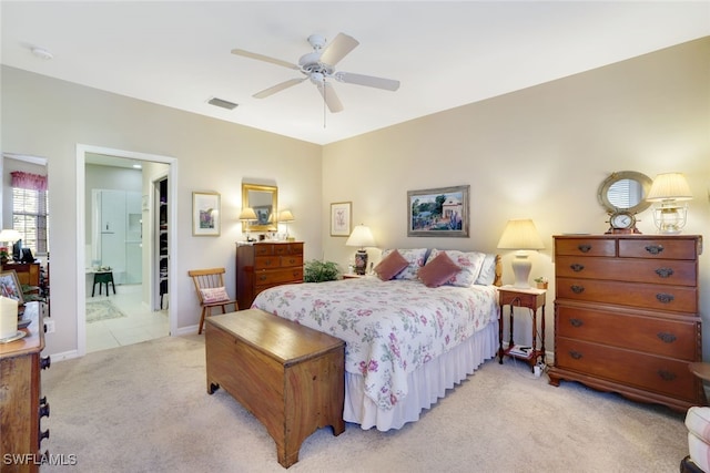 carpeted bedroom featuring ceiling fan and connected bathroom