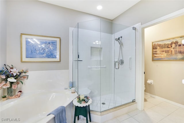 bathroom featuring tile patterned floors, toilet, and shower with separate bathtub