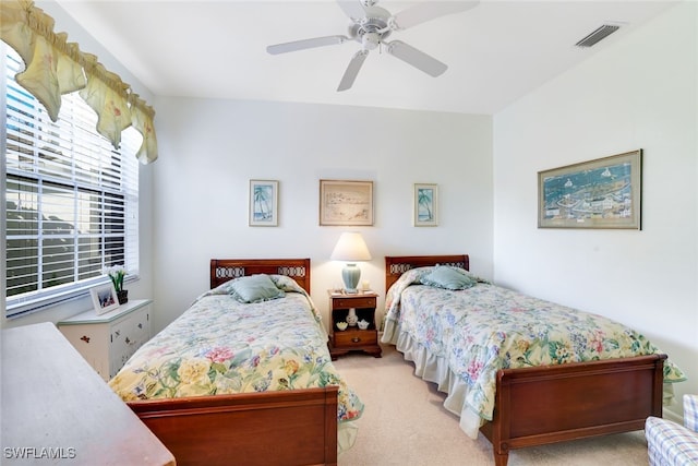 bedroom with ceiling fan and light carpet