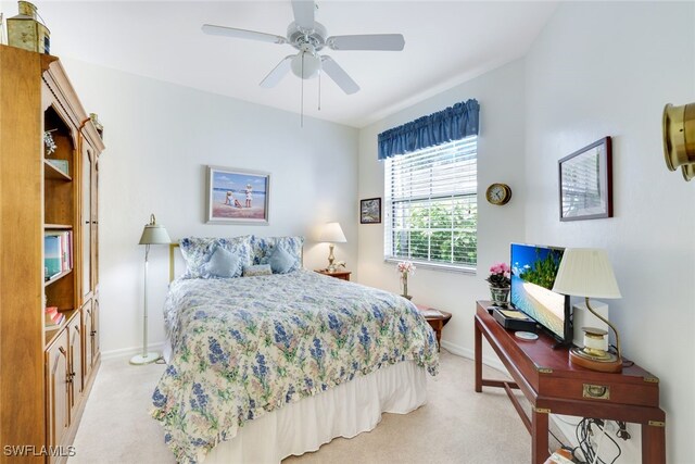 carpeted bedroom featuring ceiling fan and vaulted ceiling