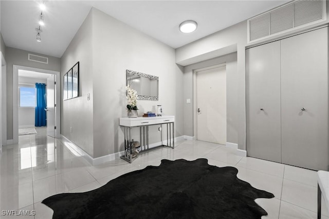 hall with light tile patterned floors