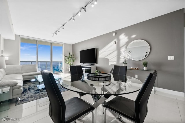 tiled dining area featuring track lighting