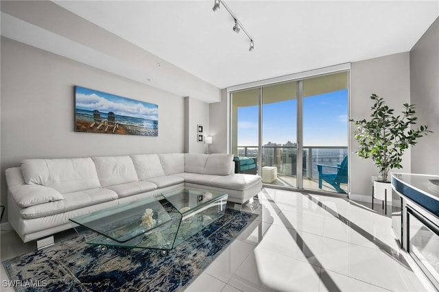 living room with tile patterned floors, floor to ceiling windows, and track lighting