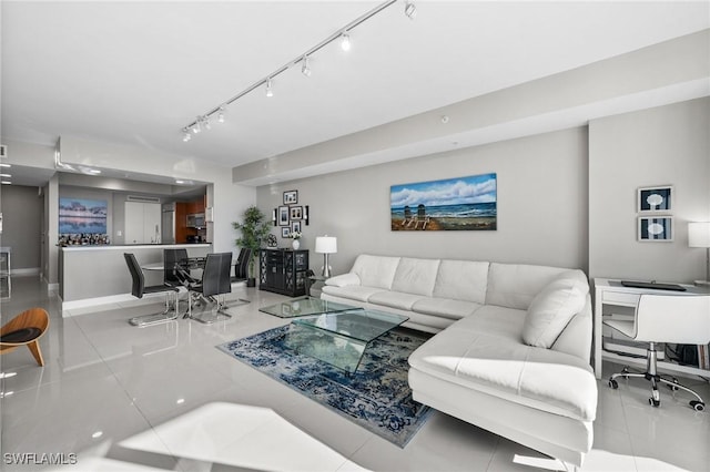 living room featuring light tile patterned floors and track lighting