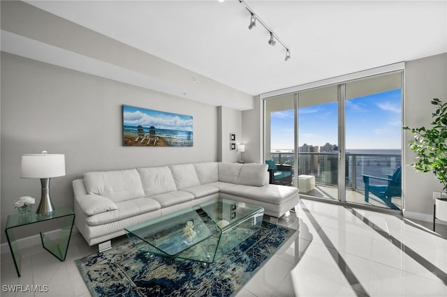 tiled living room featuring floor to ceiling windows and rail lighting