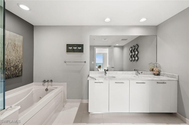 bathroom featuring a washtub and vanity