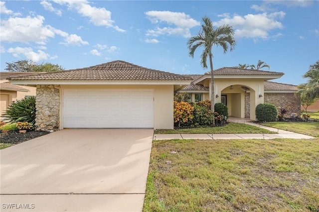 view of front of home with a garage and a front lawn