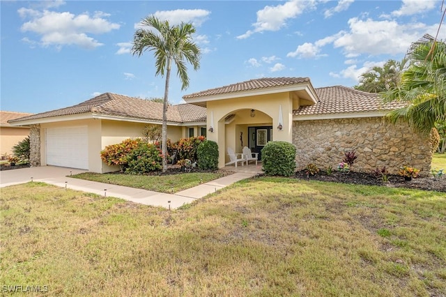 mediterranean / spanish-style house with a front yard and a garage