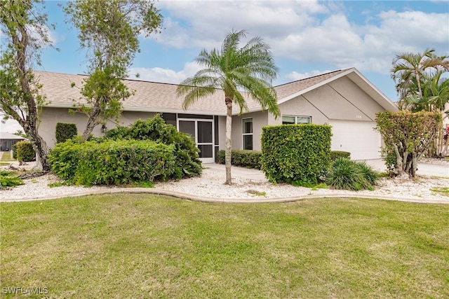 ranch-style house featuring a garage and a front lawn