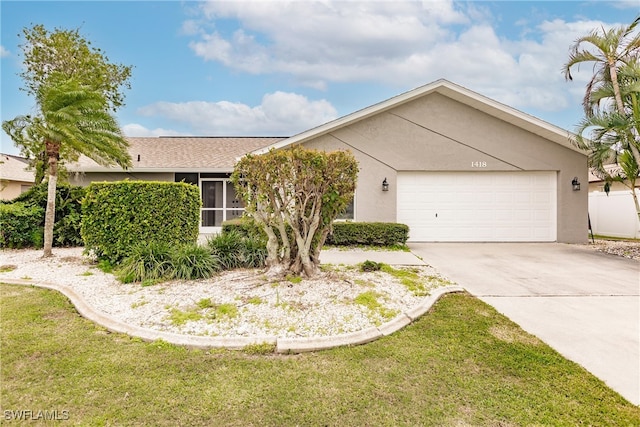 single story home featuring a front yard and a garage