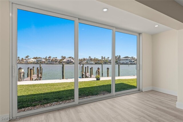 unfurnished sunroom with a water view