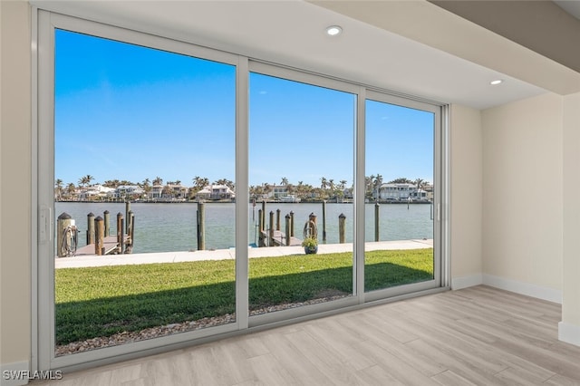 unfurnished sunroom featuring a water view