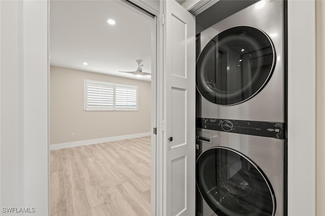 washroom featuring recessed lighting, stacked washer and dryer, laundry area, baseboards, and light wood finished floors