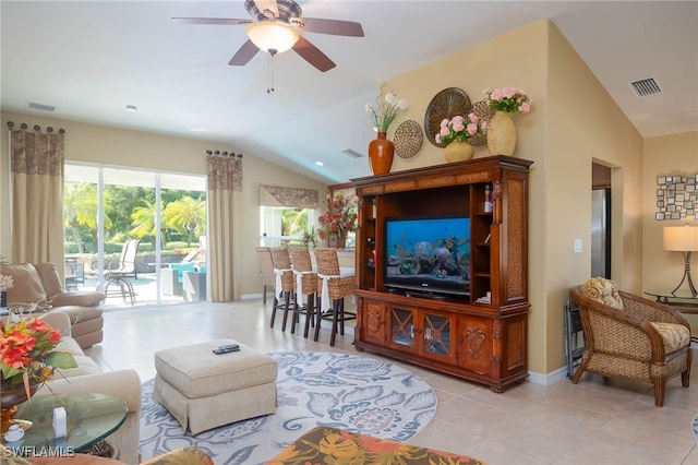 living room featuring ceiling fan, lofted ceiling, and light tile patterned floors