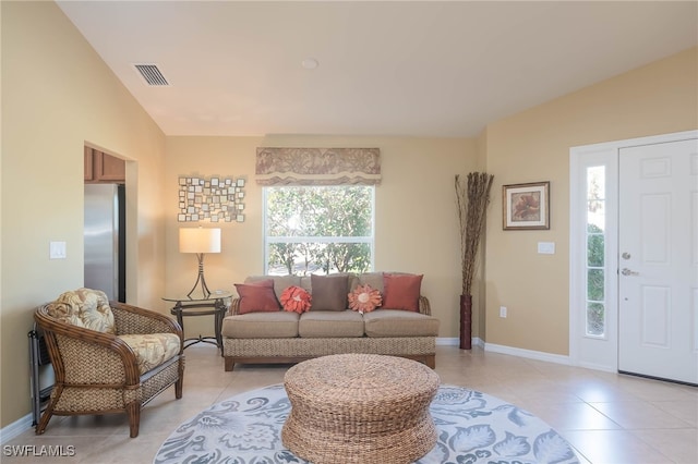 tiled living room featuring a wealth of natural light and vaulted ceiling