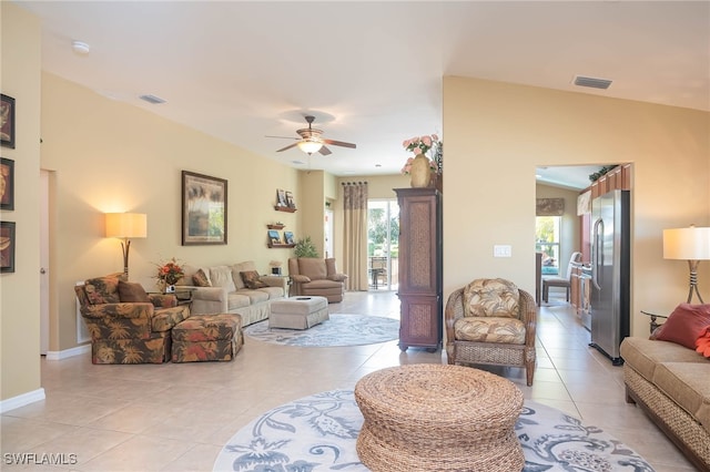 tiled living room with ceiling fan and vaulted ceiling