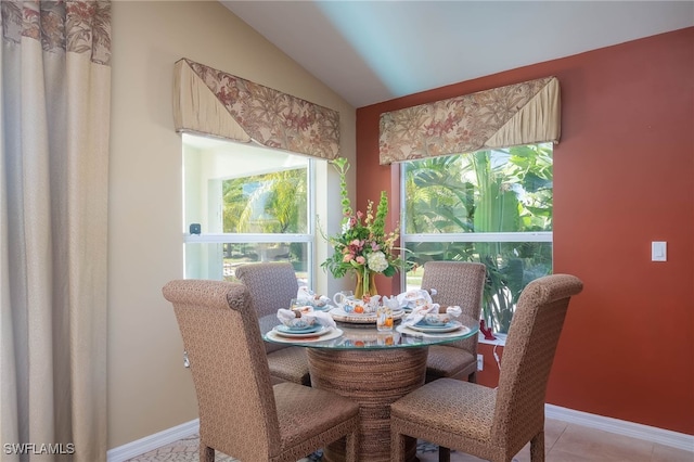 dining space featuring lofted ceiling