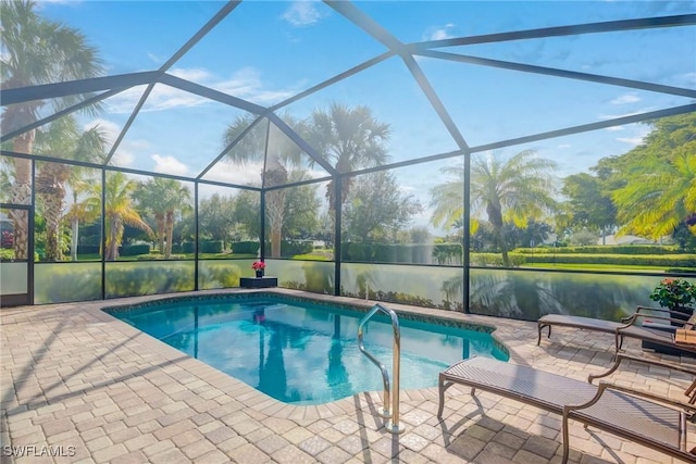 view of pool with a lanai, a patio, and a water view