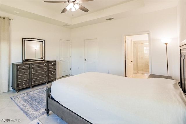 bedroom with connected bathroom, ceiling fan, and light tile patterned floors