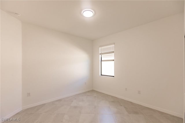 spare room featuring light tile patterned flooring