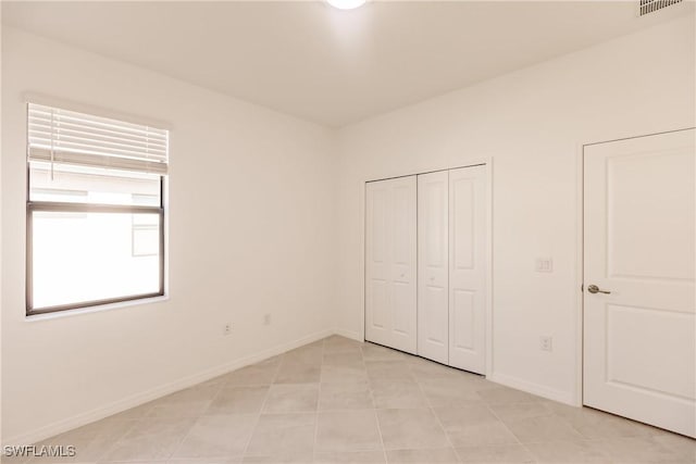 unfurnished bedroom with light tile patterned floors