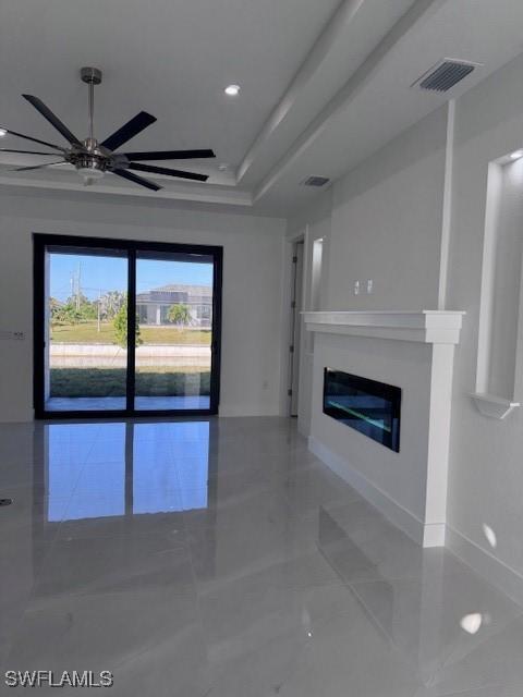 unfurnished living room featuring ceiling fan