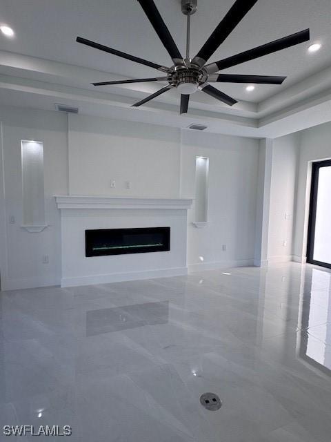 unfurnished living room with ceiling fan