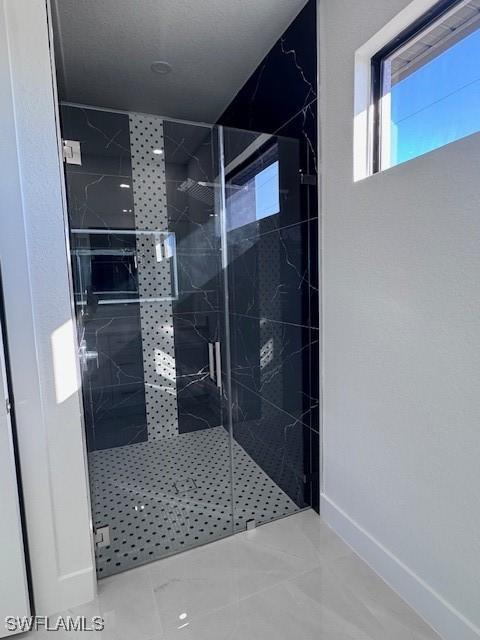 bathroom featuring a shower with door