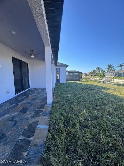 view of yard featuring ceiling fan