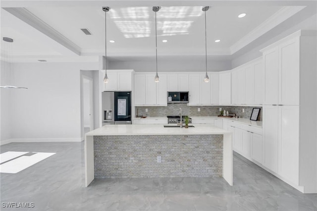 kitchen featuring hanging light fixtures, stainless steel appliances, crown molding, a kitchen island with sink, and white cabinets