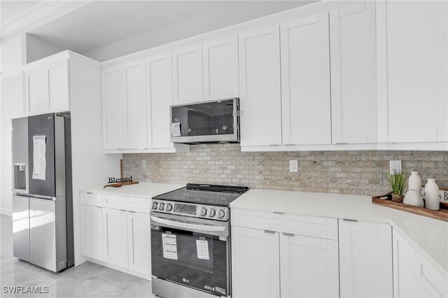 kitchen with tasteful backsplash, white cabinetry, and appliances with stainless steel finishes