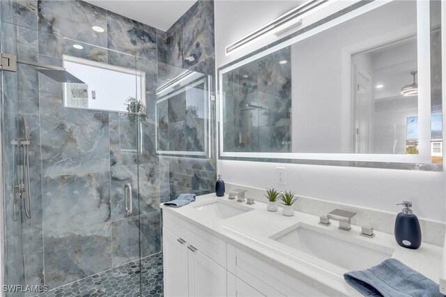 bathroom with vanity and a shower with shower door