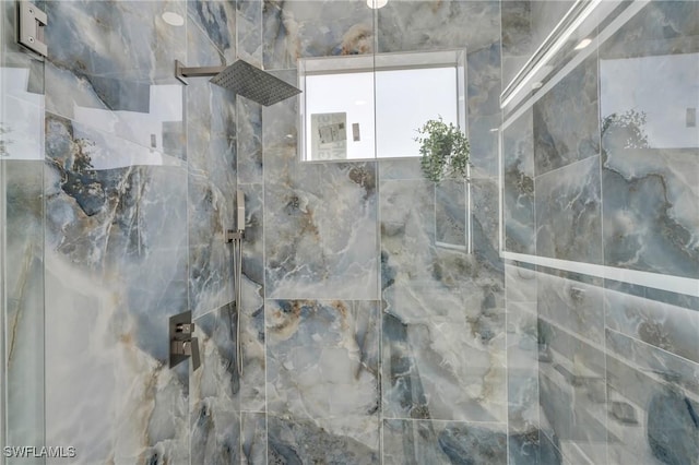 interior details with a tile shower