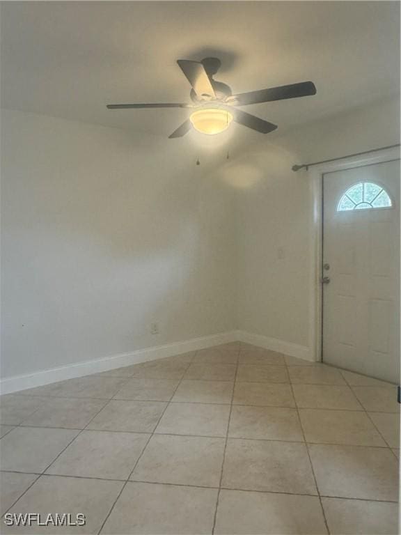 tiled entryway featuring ceiling fan