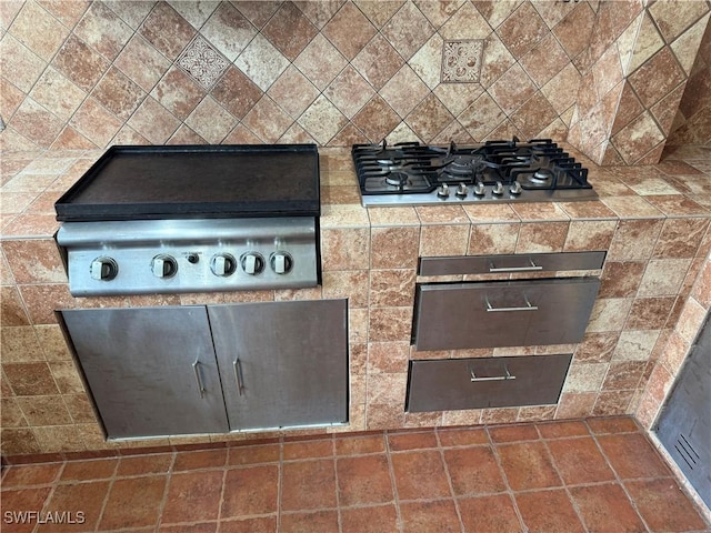 room details featuring decorative backsplash and stainless steel gas cooktop