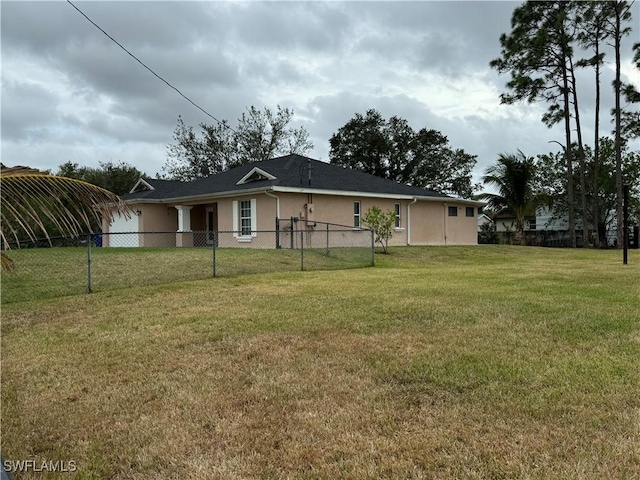 back of property with a lawn