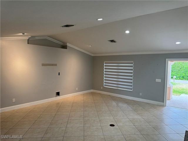 spare room with lofted ceiling, light tile patterned flooring, and ornamental molding