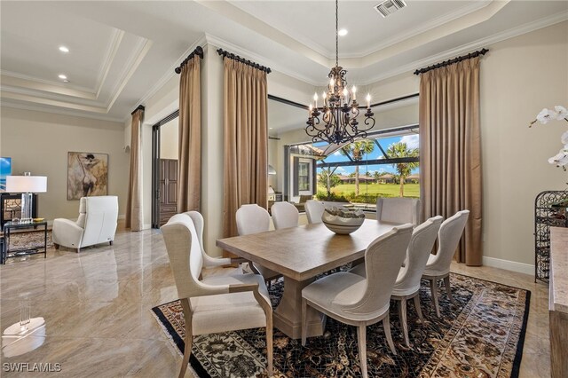 dining area featuring a notable chandelier, a raised ceiling, and ornamental molding