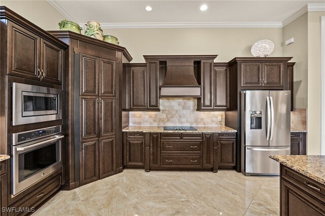 kitchen featuring dark brown cabinetry, stainless steel appliances, custom range hood, and ornamental molding