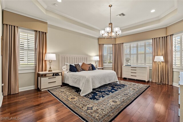 bedroom with ornamental molding, a raised ceiling, and dark wood-type flooring