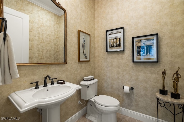 bathroom featuring tile patterned flooring, toilet, and ornamental molding