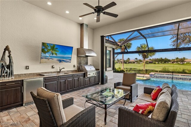 view of patio / terrace with an outdoor kitchen, a lanai, a grill, an outdoor hangout area, and pool water feature