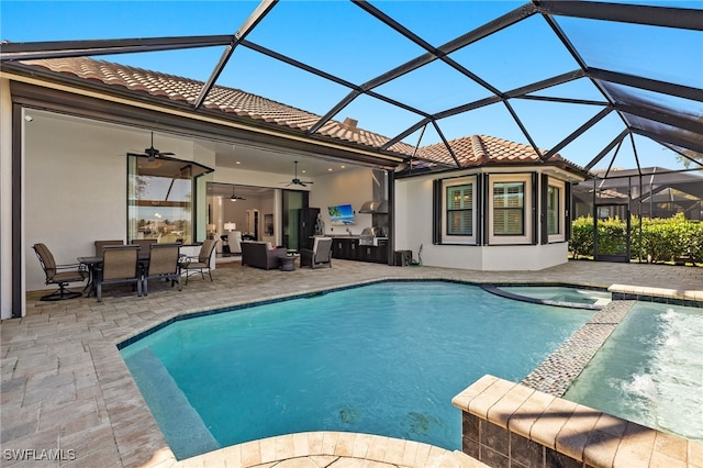 view of swimming pool featuring ceiling fan, a lanai, and a patio